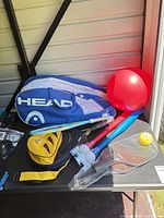 Head racquet bag, kids bats, paddleball set, red ball, wiffle ball