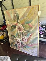 Front view of framed floral abstract painting