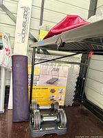 Overall lot with dumbbells on bases, floor-mat box, rolled yoga mat