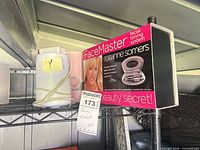 Shelf view showing Suzanne Somers FaceMaster boxed set and unbranded white cylindrical humidifier