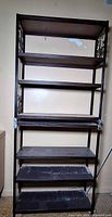 Full view of stacked metal shelving units showing shelves and frame