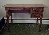 Front view of desk showing overall structure, two drawers, legs
