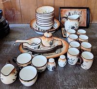 Full assortment of plates, bowls, mugs, serving pieces displayed