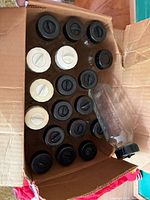Box containing about 20 glass baby bottles with caps