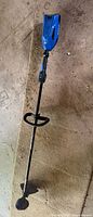 Full view of Kobalt 40V Max string trimmer lying on floor