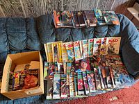 Wide view of all magazines spread on couch and in box