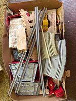 Box showing mixed track sections, guard rails, cars and accessories