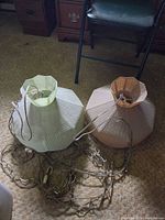 Both lamps side by side on floor with chains visible