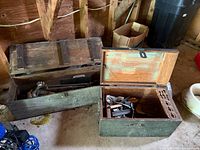 Two wooden tool chests, one open showing tools, overall view