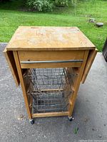 Front view showing cart, drawer, baskets, casters