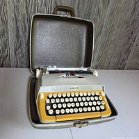 Typewriter in open carrying case showing overall appearance