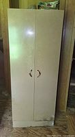 Front view of beige metal locker cabinet showing two doors and handles