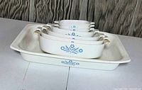 Side view of nested roaster and five casseroles showing pattern and handles