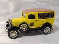 Right side view of yellow/black die-cast Model A panel truck coin bank