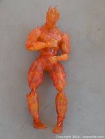 Full view of translucent orange Human Torch figure standing upright