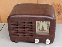 Front three-quarter view of brown Bakelite GE tube radio