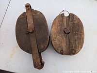 pair of large wooden pulleys top view