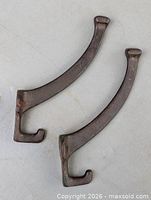 Both forged metal coat hooks front view