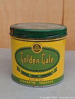 Front view of cylindrical Golden Gate tobacco tin
