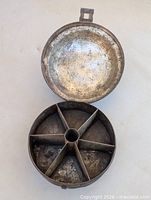 Mold open showing six wedge partitions and center tube