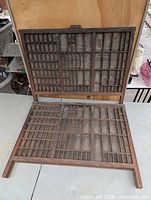 Both wooden printers trays, one leaning, one flat, showing full compartment layout