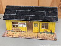 Front exterior view showing Lumar Construction Company sign, yellow walls, black roof
