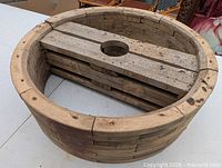 Full circular wooden wheel mold showing segmented rim and interior hub planks