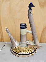 Front view of stoneware kettle sculpture showing spout, lid and chimney column