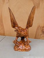Front view of carved wood eagle with wings up
