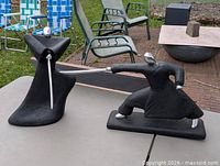 Both sculptures on outdoor table showing overall forms