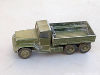 Left side profile of olive drab diecast military truck