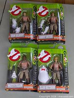 Front view of four boxed Ghostbusters figures