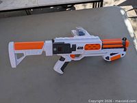 Left side view of full blaster showing stock, body and barrel