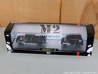 Front view of boxed M2 Machines die-cast vehicle set