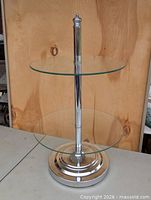 Full view of two-tier chrome and glass table
