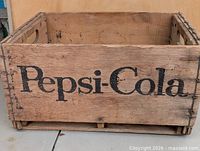 Front view showing Pepsi-Cola logo and crate construction