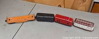 Four tin train cars lined up on table