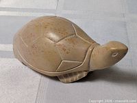 Top and side view of beige soapstone turtle figurine