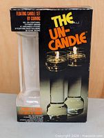 Front of boxed Corning The Un-Candle set showing product image and contents
