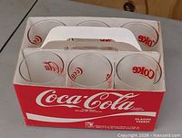 Top view of carry box showing six tumblers and Coca-Cola branding