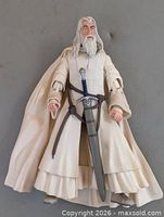 Full front view of Gandalf figure with cloak and sword