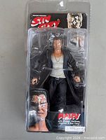 Front view of unopened Marv figure in Sin City packaging