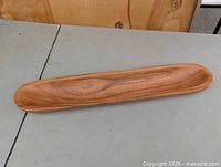 Full view of long oval wooden tray