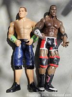 Front view of both wrestling figures standing side by side