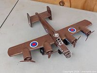 Top view of metal RAF bomber model showing wings, propellers, roundels