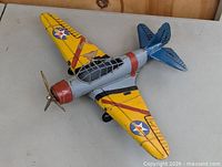 Three-quarter view of the metal WWII fighter plane model showing star insignia and propeller