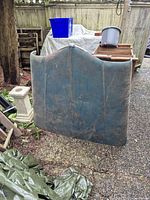 Front view of vintage Willys steel hood, exterior green with patina