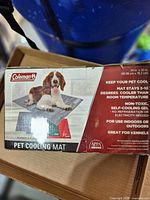 Front of retail box showing Coleman gray pet cooling mat and dog image