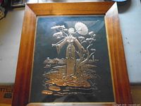 Wood-framed metal relief of kimono-clad woman with parasol