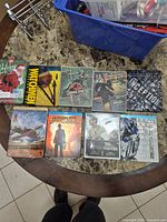 Top view showing all nine Blu-ray and DVD cases on table